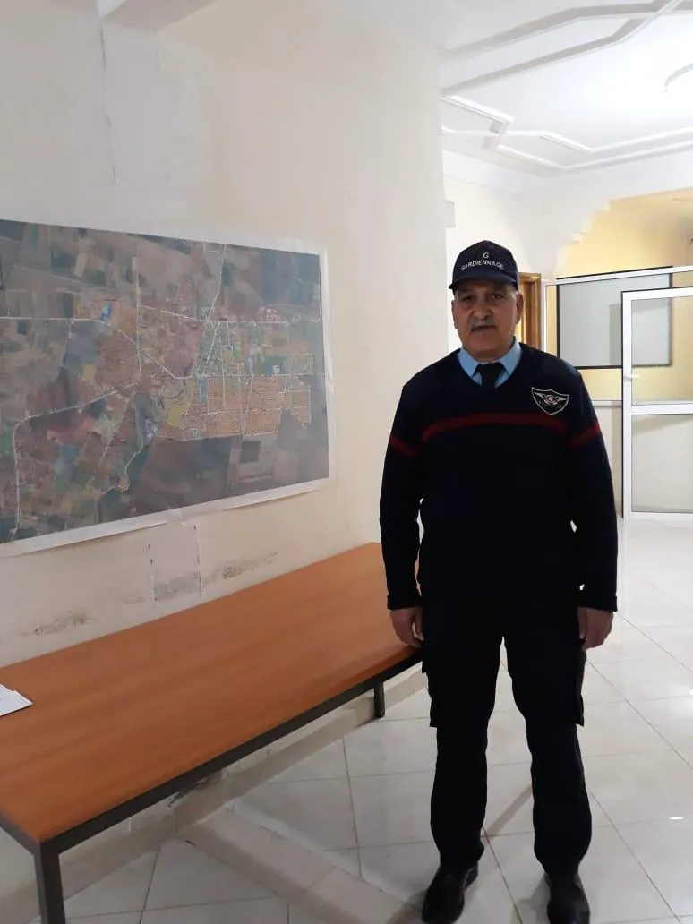 Agent TIHAMA en poste dans un couloir administratif.